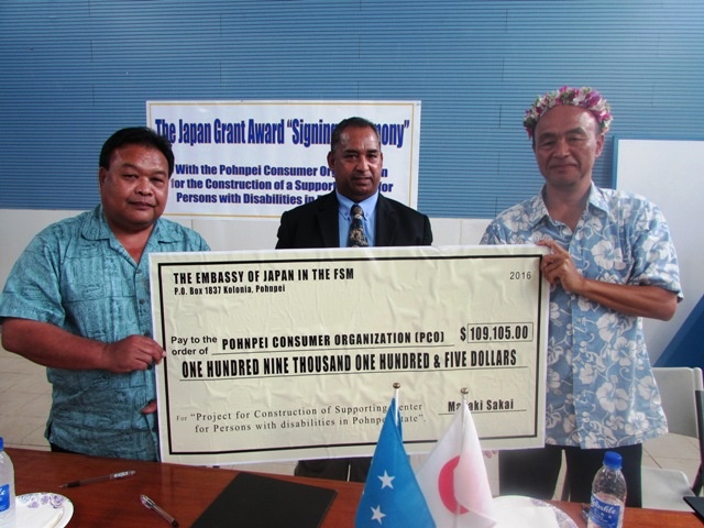 Handing Over a Big Check From right) Ambassador Sakai, President Perez, Lt. Governor Oliver